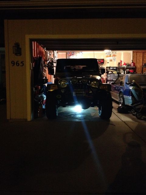 2005 Jeep Wrangler - A Jeep Wrangler is parked in a garage next to another vehicle.
