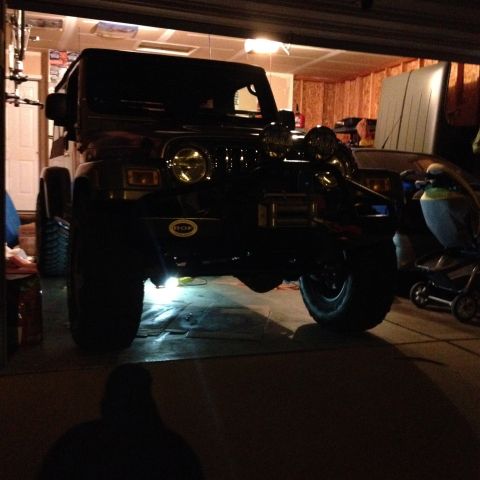 2005 Jeep Wrangler - Front view of a black 2005 Jeep Wrangler parked inside a garage.