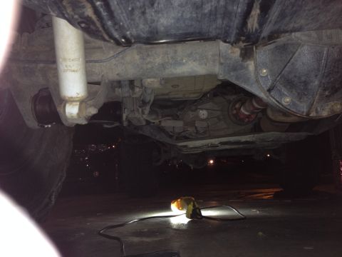 2005 Jeep Wrangler - Underside view of a 2005 Jeep Wrangler, focusing on the drivetrain and suspension parts.