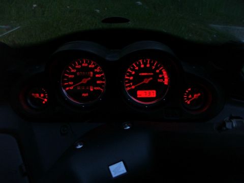2006 Honda Reflex - The illuminated dashboard gauges feature red lighting for the mph and rpm dials, along with a digital display.