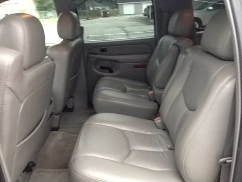 2005 Chevrolet Suburban - Interior view of a 2005 Chevrolet Suburban, highlighting the spacious seating arrangement and gray leather upholstery.