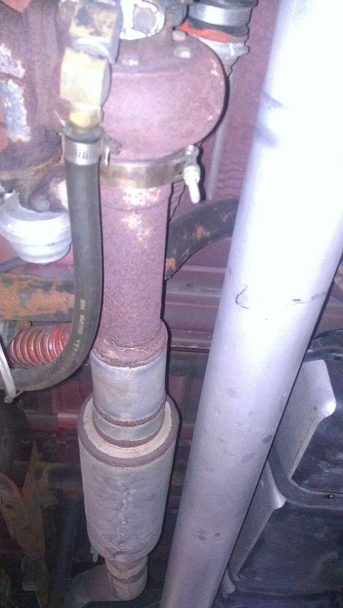 2005 Chevrolet Suburban - Underside view of a vehicle's exhaust system components, showing rust and wear.