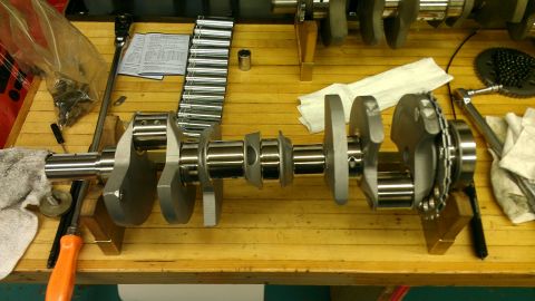 2005 Chevrolet Suburban - A crankshaft is shown on a workbench, surrounded by various tools and a socket set.