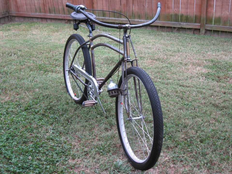 Front view of a chrome bicycle with wide handlebars and a bell