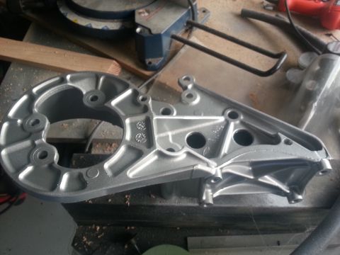 1994 Ford Bronco - A metal bracket is shown on a workbench, with a miter saw in the background.