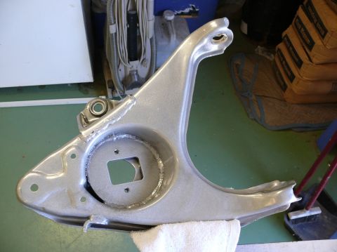1976 Chevrolet Corvette - A single automotive suspension control arm is shown, with visible welding and a bearing assembly.