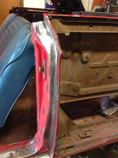 1964 Ford Fairlane - Interior view of a 1964 Ford Fairlane door jamb, showing the blue seat and red exterior.