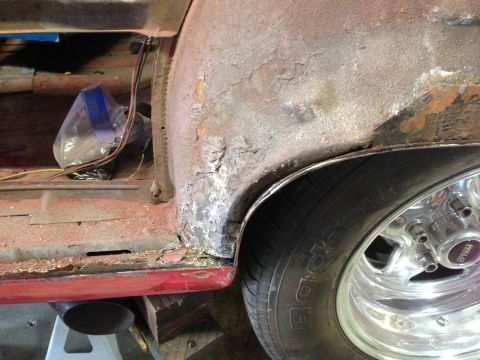 1964 Ford Fairlane - The rear quarter panel of a 1964 Ford Fairlane shows significant rust and damage, with a Weld wheel visible.