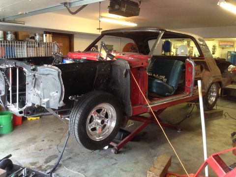 1964 Ford Fairlane - A 1964 Ford Fairlane is shown in a garage, partially disassembled for restoration work.
