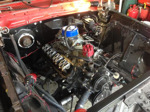 1964 Ford Fairlane - Close-up view of a V8 engine installed in a vehicle's engine bay, showing the carburetor and distributor.