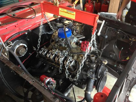 1964 Ford Fairlane - An engine hoist is used to remove the V8 engine from the vehicle's engine bay.