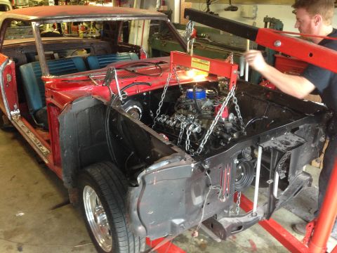 1964 Ford Fairlane - A 1964 Ford Fairlane is being worked on, with its engine suspended by a hoist.