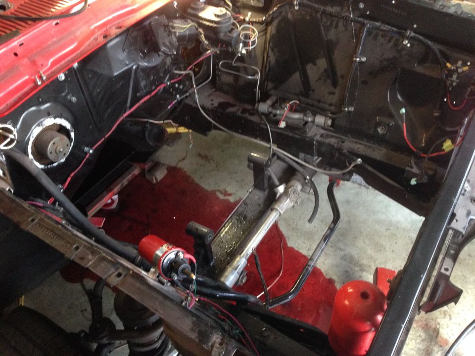 1964 Ford Fairlane engine bay with red paint, black components, and visible wiring