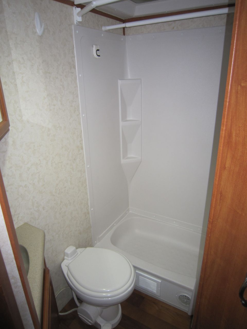 RV bathroom with toilet and shower stall