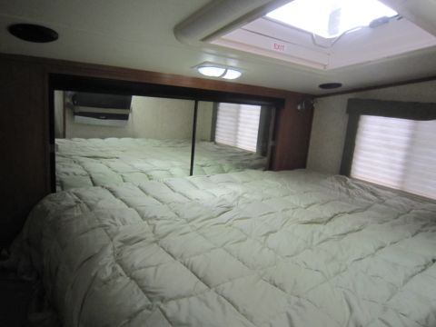 2008 Ford F-450 - Interior view of an RV bedroom, showing a large bed and mirrored closet doors.