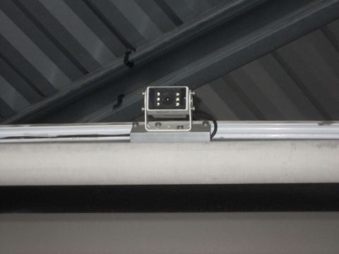 2008 Ford F-450 - A small black security camera is mounted on a silver bracket attached to a metal rail.