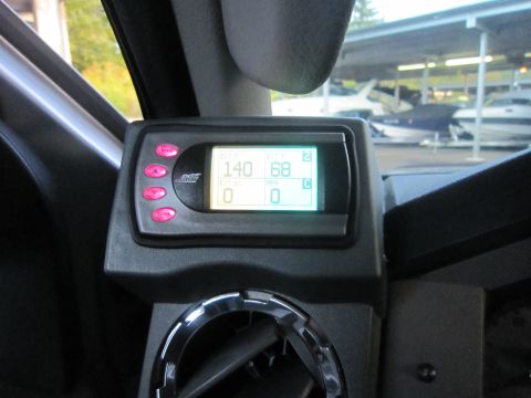 2008 Ford F-450 - A digital gauge display with pink buttons is mounted inside a vehicle, showing various readings.