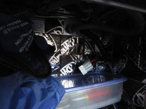 2008 Ford F-450 - Storage compartment interior with insulation and various items.