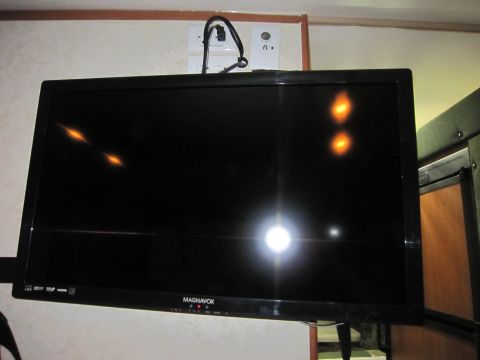 2008 Ford F-450 - A television is mounted on the wall, reflecting lights from the room.