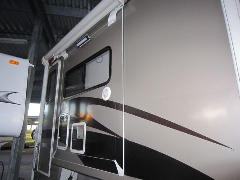 2008 Ford F-450 - An RV camper is shown parked indoors next to another recreational vehicle.