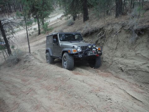 2005 Jeep Wrangler - Jeep Wrangler navigates a steep, sandy incline on an off-road trail.