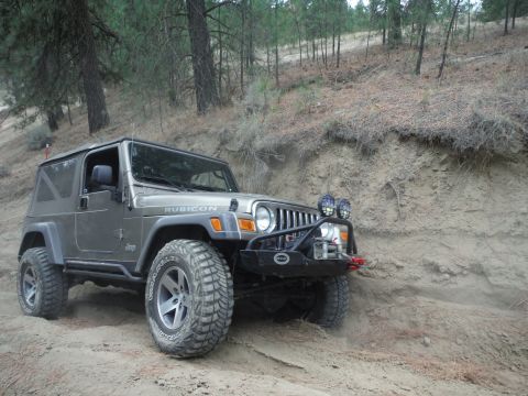 2005 Jeep Wrangler - This Jeep Wrangler TJ is navigating a sandy, wooded incline.