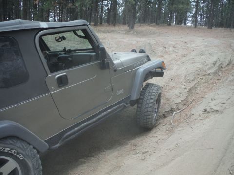 2005 Jeep Wrangler - A Jeep Wrangler navigates a sandy off-road trail.