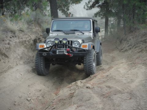 2005 Jeep Wrangler - A 2005 Jeep Wrangler navigates a dusty off-road trail.
