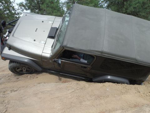2005 Jeep Wrangler - Jeep Wrangler navigating off-road terrain with a soft top.