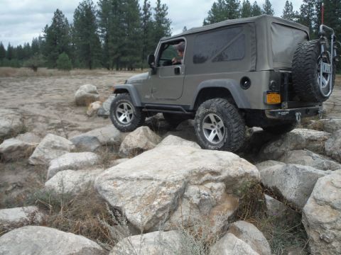 2005 Jeep Wrangler - A gray 2005 Jeep Wrangler TJ navigates a rocky off-road trail.