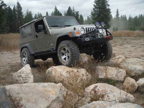 2005 Jeep Wrangler - Jeep Wrangler Rubicon navigating a rocky off-road course under an overcast sky.