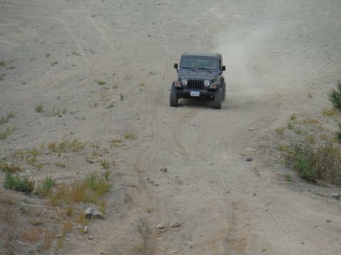 2005 Jeep Wrangler - A Jeep Wrangler navigates a dusty off-road trail.