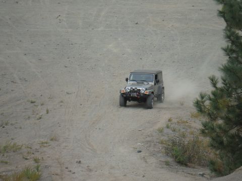 2005 Jeep Wrangler - A Jeep Wrangler navigates a dusty off-road trail.