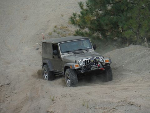 2005 Jeep Wrangler - A silver 2005 Jeep Wrangler Rubicon navigates a dusty off-road trail.