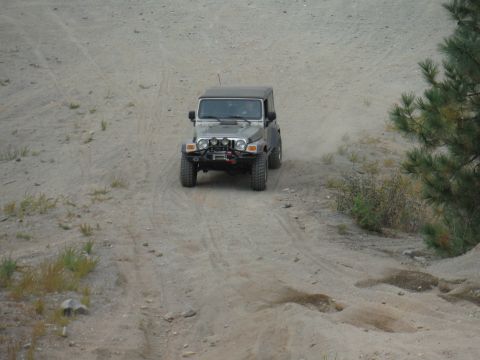 2005 Jeep Wrangler - A 2005 Jeep Wrangler navigates a dusty, off-road path.
