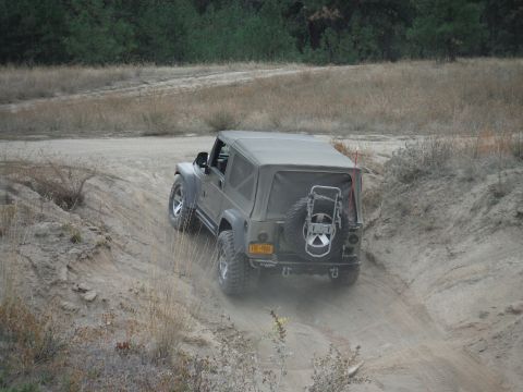 2005 Jeep Wrangler - A 2005 Jeep Wrangler navigates a dusty off-road trail.