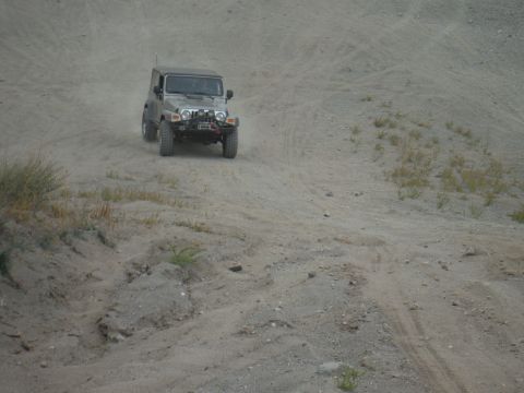 2005 Jeep Wrangler - A Jeep Wrangler navigates a dusty, off-road trail.