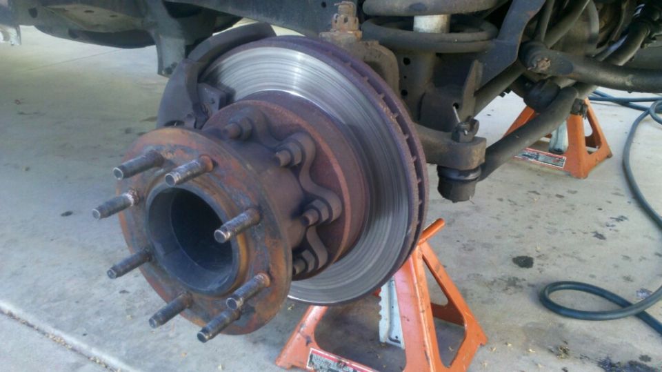 Front wheel hub and brake rotor on jack stands. 1997 Dodge 3500