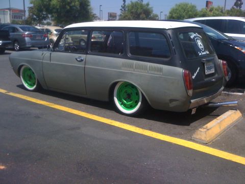 1968 Ford Mustang - This two-tone station wagon features bright green wheels and whitewall tires, parked in a lot.