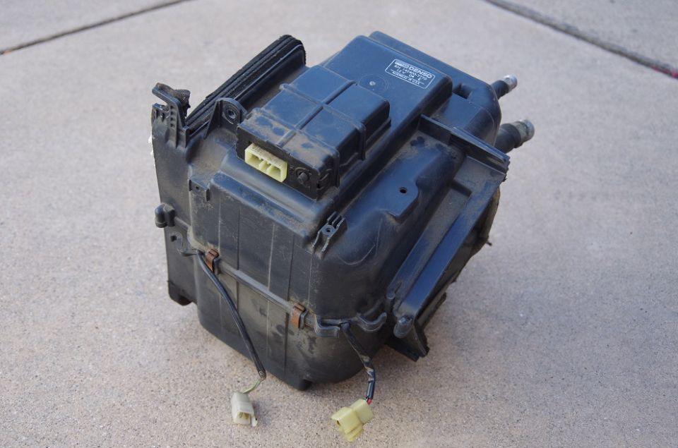 Automotive HVAC blower motor assembly with yellow electrical connectors and wiring