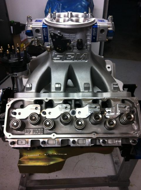 1972 Ford Ranchero - Close-up view of an engine's intake manifold and cylinder head, SEM branding and SCM 4V casting.