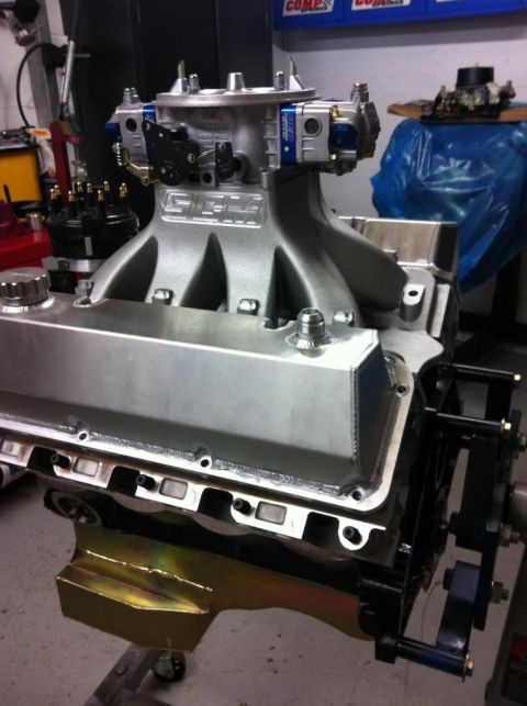 1972 Ford Ranchero - Close-up of an engine's intake manifold and carburetor assembly, with Supermotors.net logo.