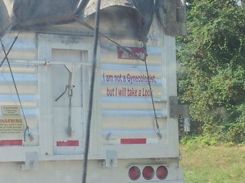 1986 Ford Bronco - This trailer displays a humorous message, suggesting a willingness to offer a 'look' despite not being a professional gynecologist.