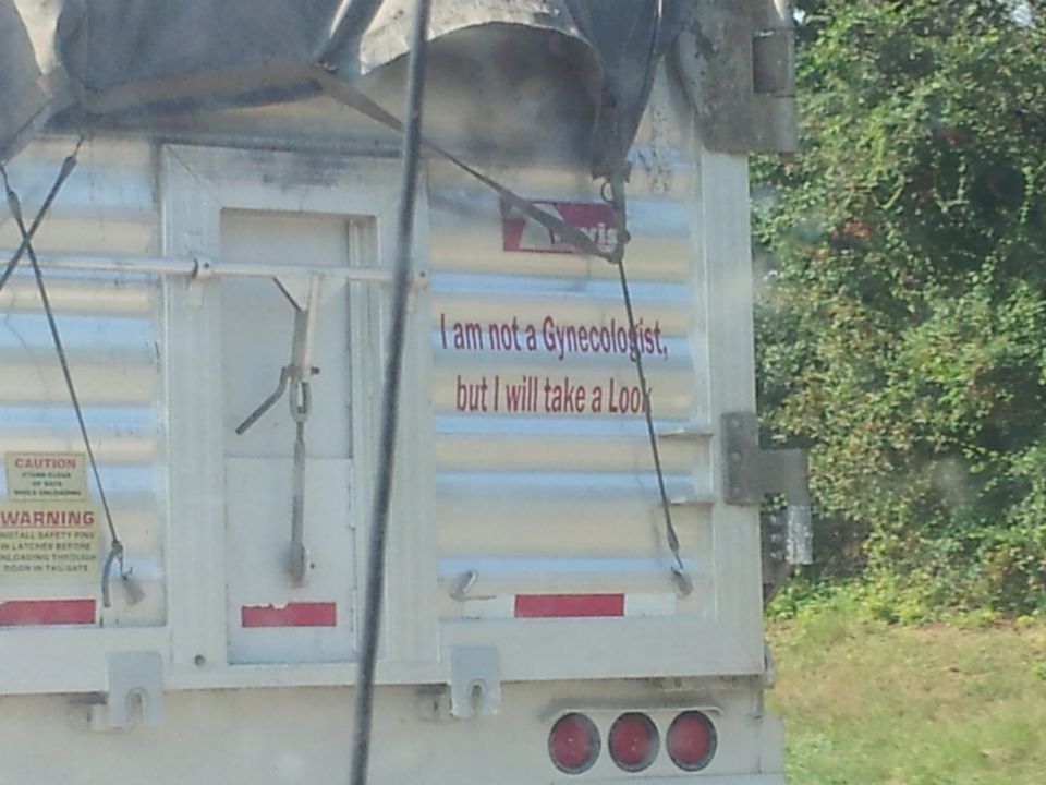 Rear of a trailer with the text 'I am not a Gynecologist, but I will take a Look'