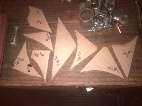 1985 Jeep CJ7 - Cardboard templates with measurements are laid out on a wooden surface next to a bolt and various tools.