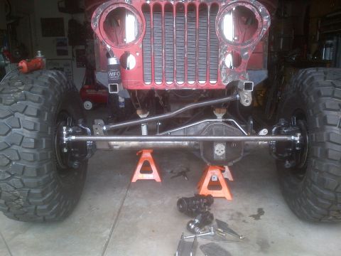 1985 Jeep CJ7 - Front end of a 1985 Jeep CJ7 undergoing work, showing the axle and suspension components.