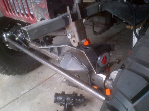 1985 Jeep CJ7 - Close-up view of a Jeep's undercarriage, highlighting suspension and drivetrain parts during a build.