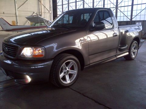 2003 Ford F-150 - This 2003 Ford F-150 Lightning pickup truck is shown in a 3q-front view, parked indoors.