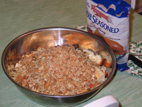 1995 Ford Bronco - A metal bowl is filled with bread cubes and stuffing mix, with a bag of seasoning nearby.