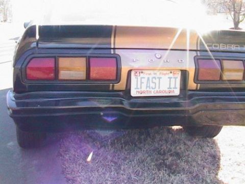 1977 Ford Mustang II - Rear view of a 1977 Ford Mustang II, gold stripes and a custom license plate.